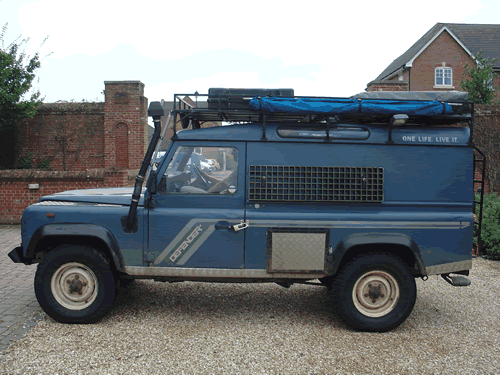 DINO, the blue Land Rover Defender 110, loaded with roof rack and jerry cans